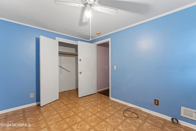 unfurnished bedroom featuring crown molding, light parquet floors, a closet, and ceiling fan