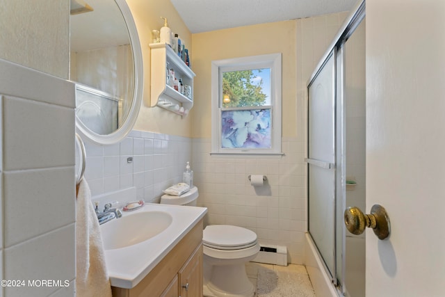 bathroom featuring toilet, tile walls, walk in shower, baseboard heating, and vanity