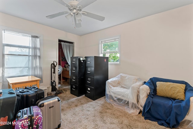 interior space with ceiling fan and light colored carpet