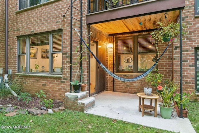 entrance to property with a balcony and a patio area