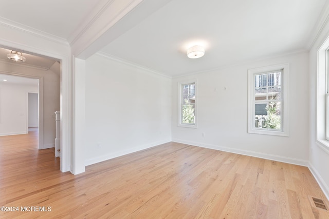 unfurnished room featuring ornamental molding and light hardwood / wood-style floors