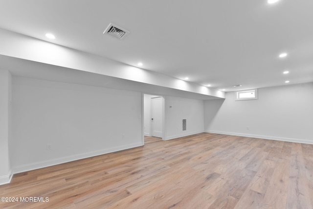 basement featuring light wood-style flooring, recessed lighting, and baseboards