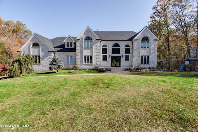 french provincial home featuring a front yard