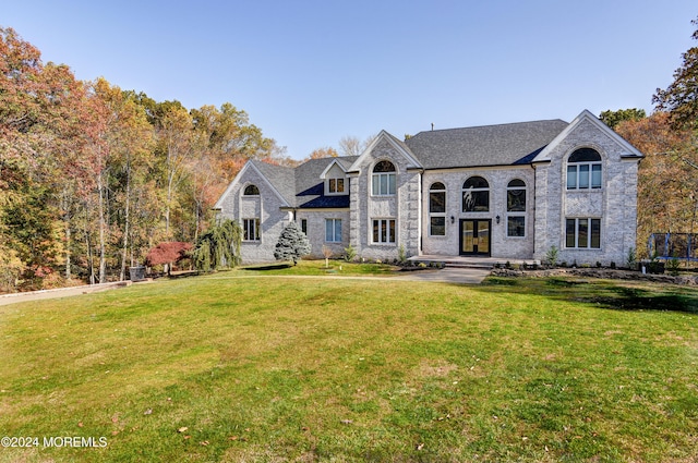 french country home featuring a front yard