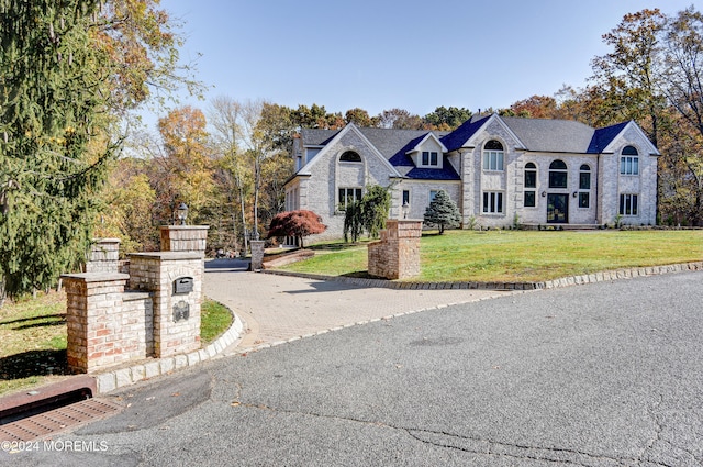 french country home featuring a front yard