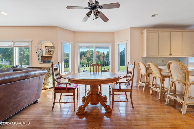 dining space with light hardwood / wood-style flooring and ceiling fan