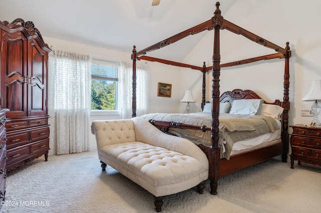 carpeted bedroom featuring ceiling fan and vaulted ceiling