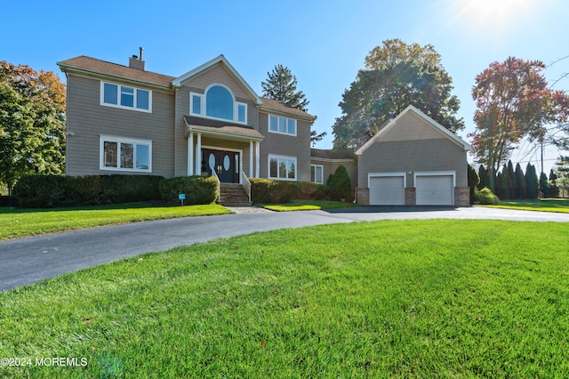 colonial home with a front lawn and a garage