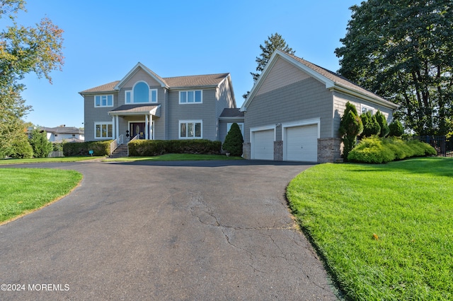 view of front of home featuring a front lawn and a garage