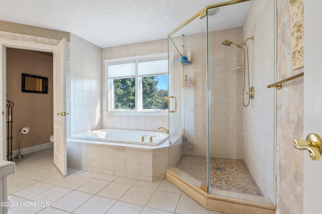 bathroom featuring toilet, shower with separate bathtub, and tile patterned floors