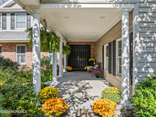 view of exterior entry with covered porch