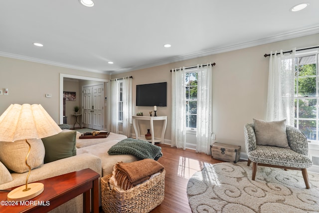 living room with ornamental molding and hardwood / wood-style flooring