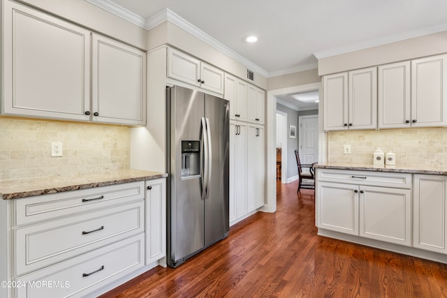 kitchen featuring stainless steel fridge with ice dispenser, white cabinetry, light stone countertops, ornamental molding, and dark hardwood / wood-style floors