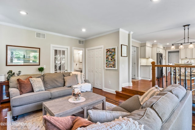 living room featuring crown molding and hardwood / wood-style floors