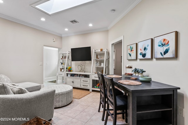 dining area with ornamental molding, a skylight, and light tile patterned floors