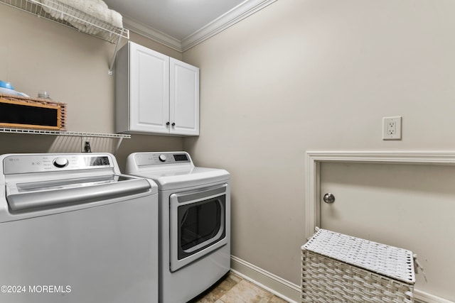 laundry room with cabinets, crown molding, and separate washer and dryer