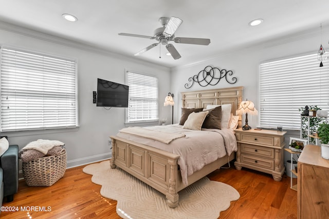 bedroom with ceiling fan, hardwood / wood-style flooring, and ornamental molding