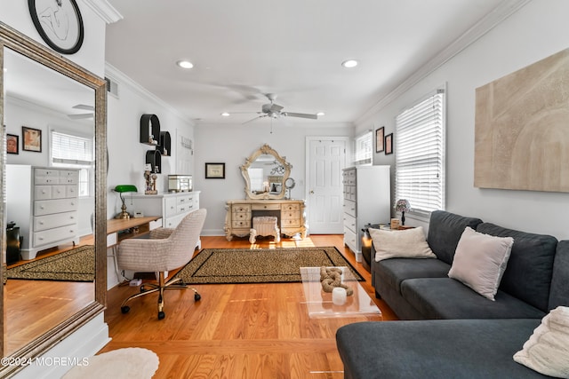 living room with hardwood / wood-style floors, crown molding, and ceiling fan