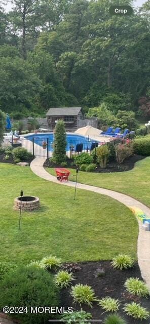 view of home's community featuring a pool and a lawn