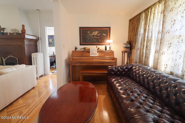 living room featuring light parquet flooring and radiator