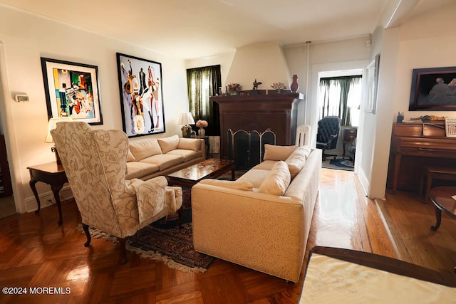 living room with parquet flooring and a large fireplace