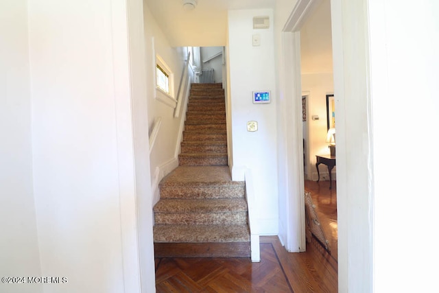 stairs featuring parquet floors