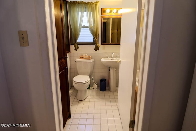 bathroom featuring tile walls, tile patterned floors, sink, and toilet