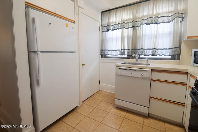 kitchen featuring sink, white cabinets, white appliances, and light tile patterned floors