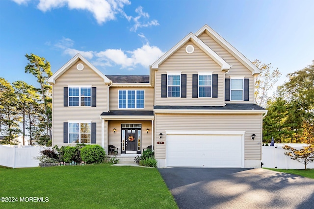 view of front of home with a front lawn and a garage