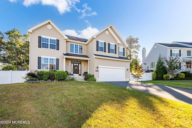 view of front of home featuring a front lawn and a garage