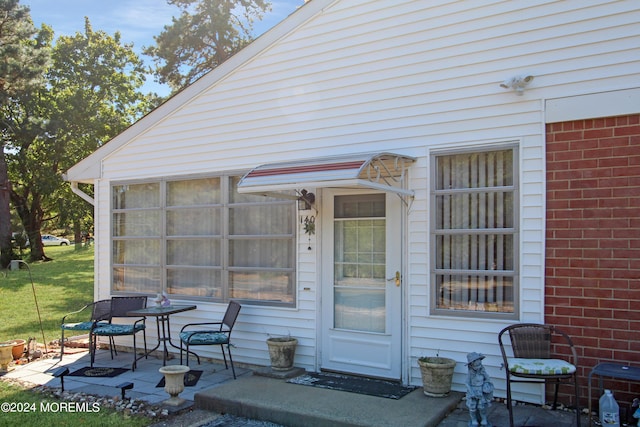 property entrance featuring a patio area