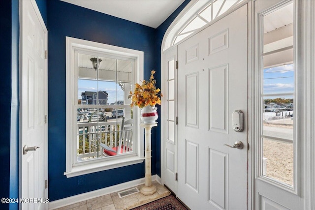 entrance foyer featuring tile patterned floors and a healthy amount of sunlight