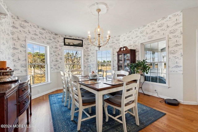 dining space featuring an inviting chandelier and wood-type flooring