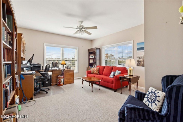 carpeted home office featuring ceiling fan