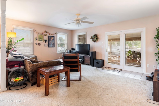 living room featuring light colored carpet and ceiling fan