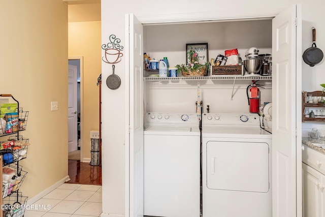 laundry area featuring independent washer and dryer and light tile patterned floors