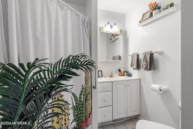 bathroom with vanity, toilet, and tile patterned floors