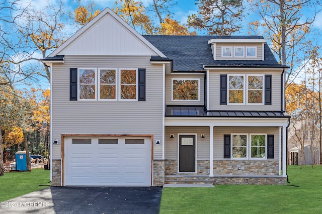 view of front of home with a garage and a front lawn