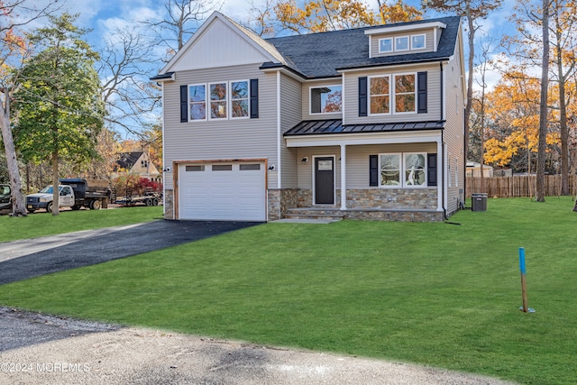 view of front of home with central AC unit, a garage, and a front lawn