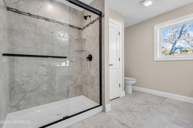 bathroom with toilet and a shower with door