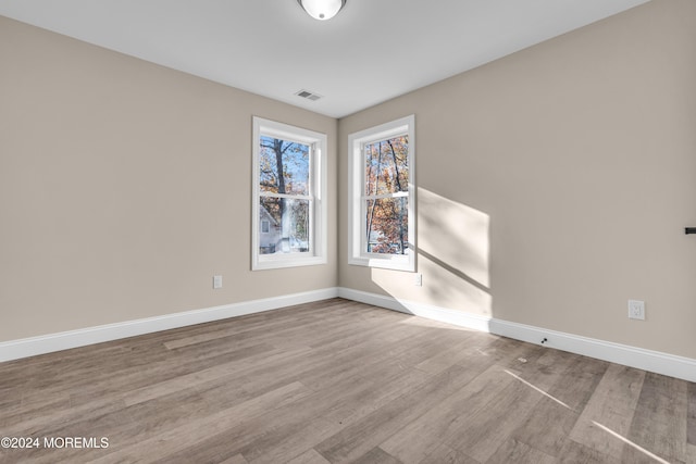 unfurnished room with light hardwood / wood-style flooring