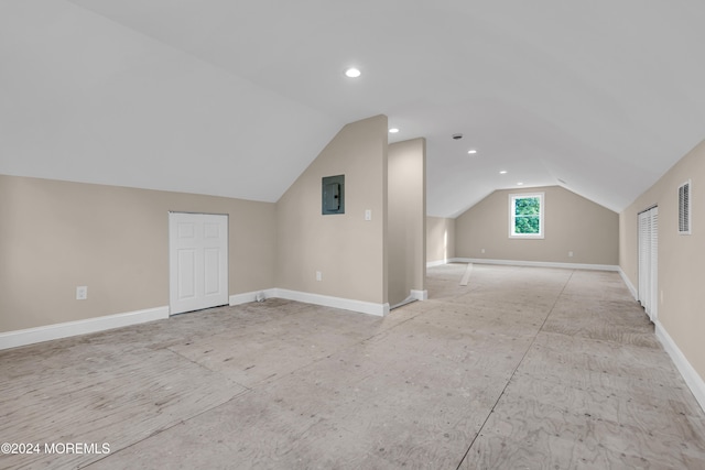 additional living space featuring lofted ceiling and electric panel