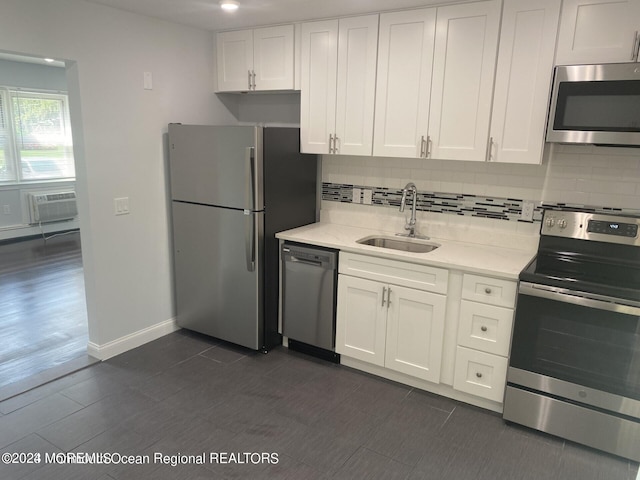 kitchen with white cabinets, tasteful backsplash, stainless steel appliances, and sink