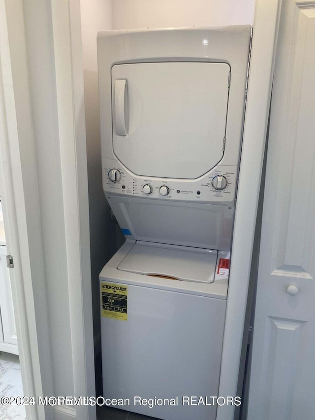 laundry room with stacked washer and clothes dryer