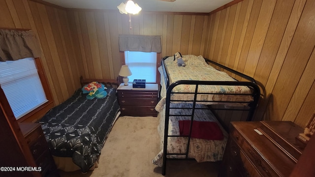 carpeted bedroom featuring wooden walls