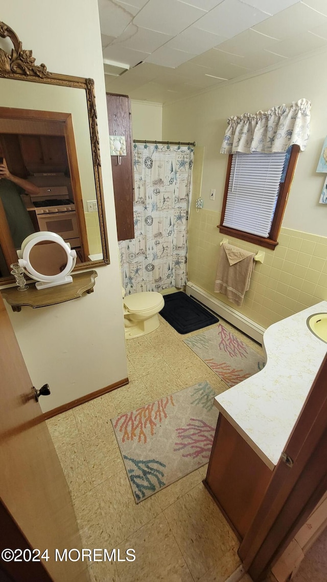 bathroom with a drop ceiling, curtained shower, toilet, tile patterned floors, and vanity