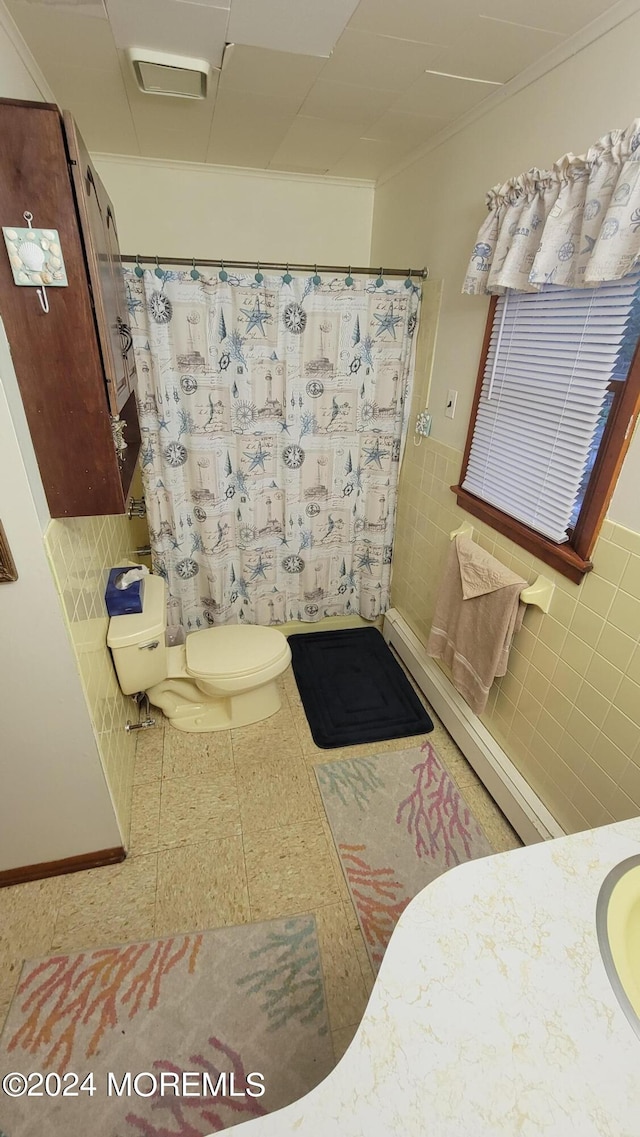 bathroom featuring toilet, tile walls, and walk in shower