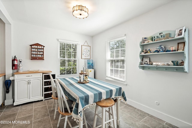 dining room with beverage cooler and dark tile patterned floors