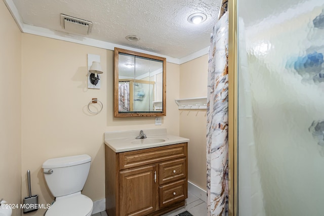 bathroom featuring vanity, curtained shower, toilet, and a textured ceiling