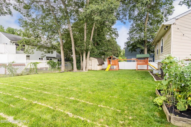 view of yard featuring a storage shed and a playground